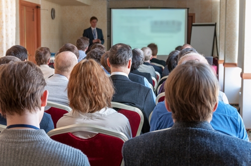 people in a conference room with a presenter