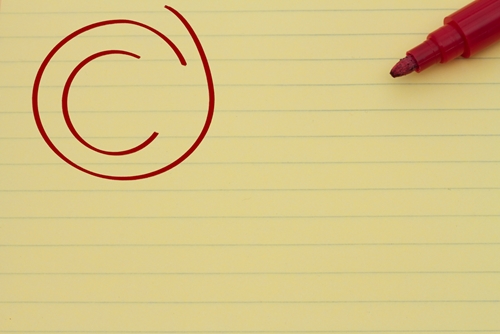 red pen with letter c in a circle on lined yellow paper