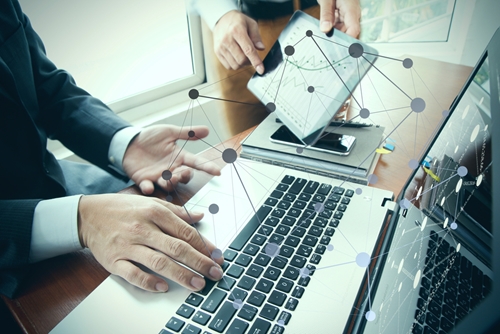 business person using keyboard of laptop