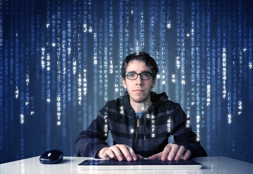 person sitting at desk with keyboard with a backdrop of digits