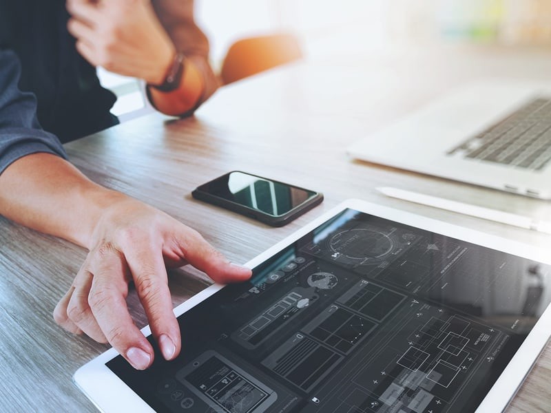designer working on digital tablet with computer laptop