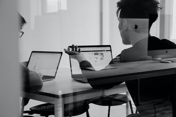 business people collaborating around a computer