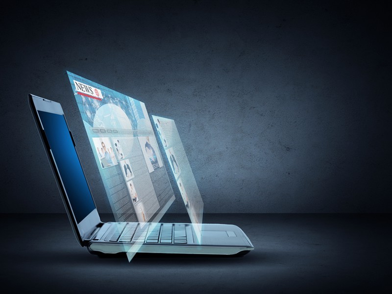 laptop computer with news page projection