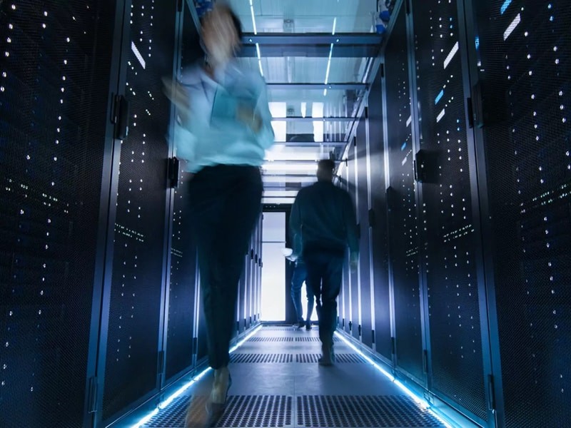 corridor in large data center with people walking and working