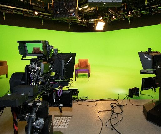 green screen studio viewed behind tv cameras