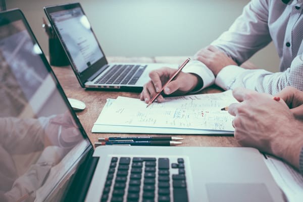 business people making changes to a hand written document