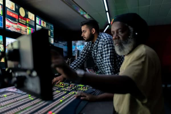 man with beard and colleague working in a studio