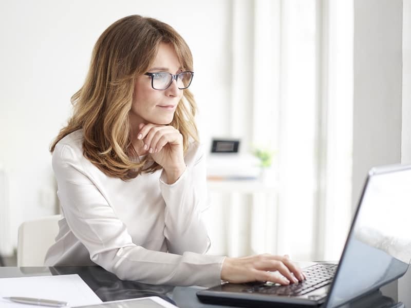 confident professional business woman working on laptop