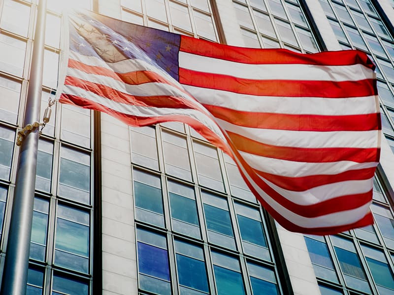 United States flag in front of office buildings