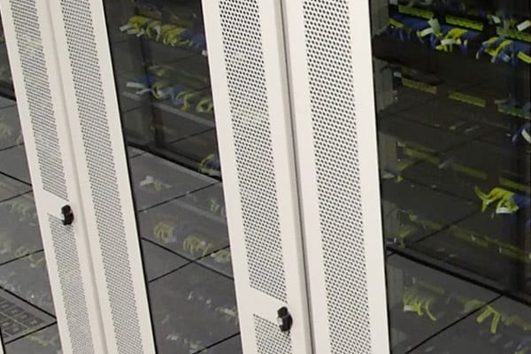 close up of servers behind glass door in a datacenter