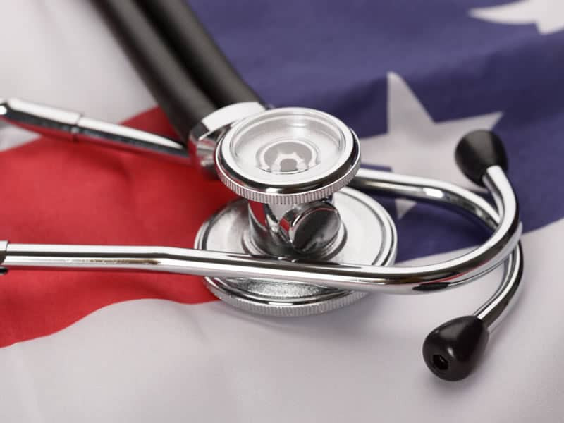 Stethoscope sitting on top of the United States flag